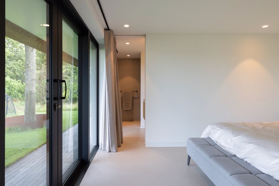 The master bedroom with sliding glass doors opening directly onto the garden.
