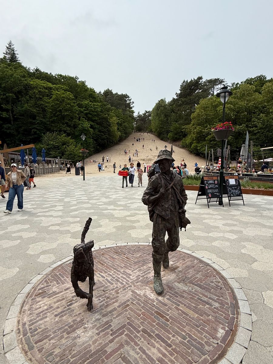 The Klimduin sand slope at Schoorl with the bronze statue in the foreground.